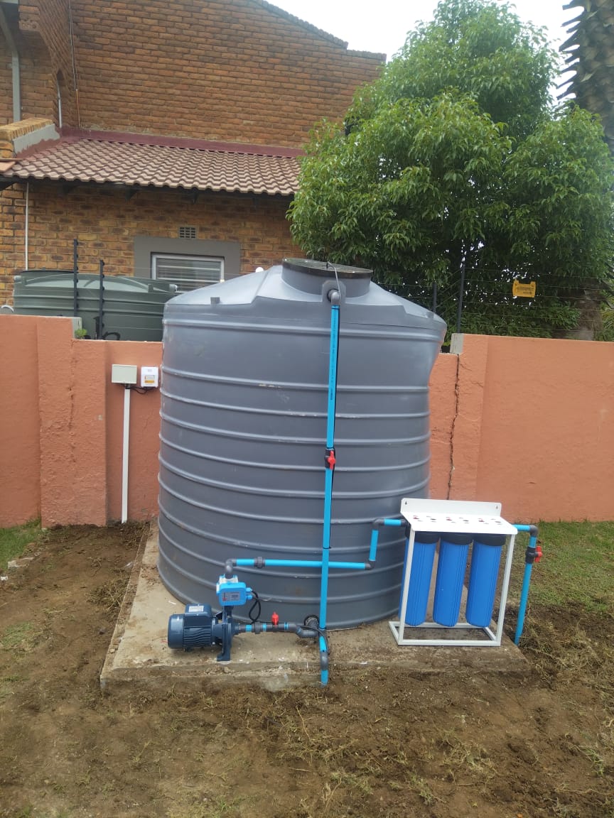 Residential borehole system with tank and pump